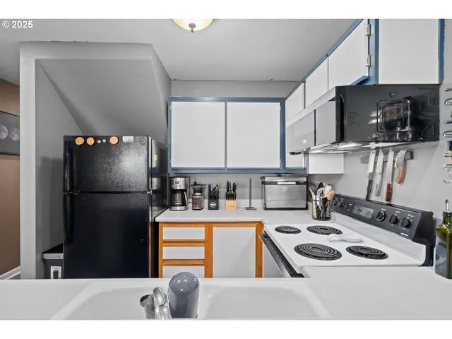 a kitchen with a refrigerator sink and microwave