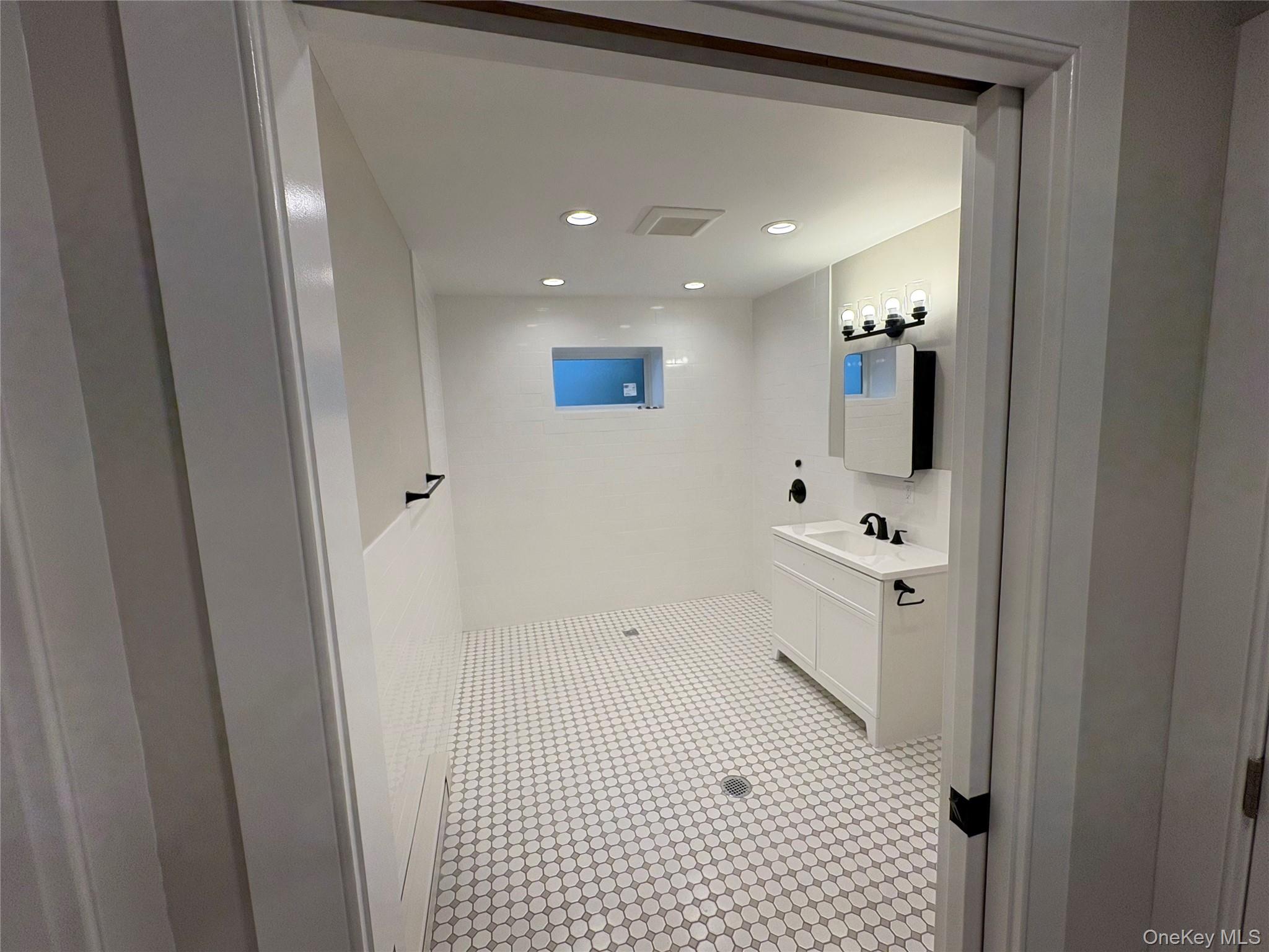 455 Sunrise Highway, Unit 1A West Babylon, NY 11704 - Photo 13 of 15 a bathroom with a sink and mirror