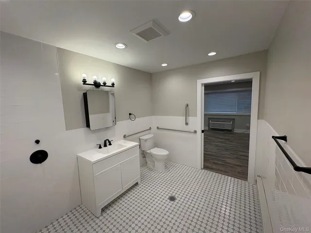 a bathroom with a sink a toilet and mirror