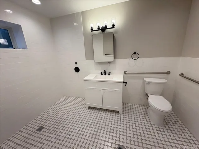 a bathroom with a sink toilet and mirror