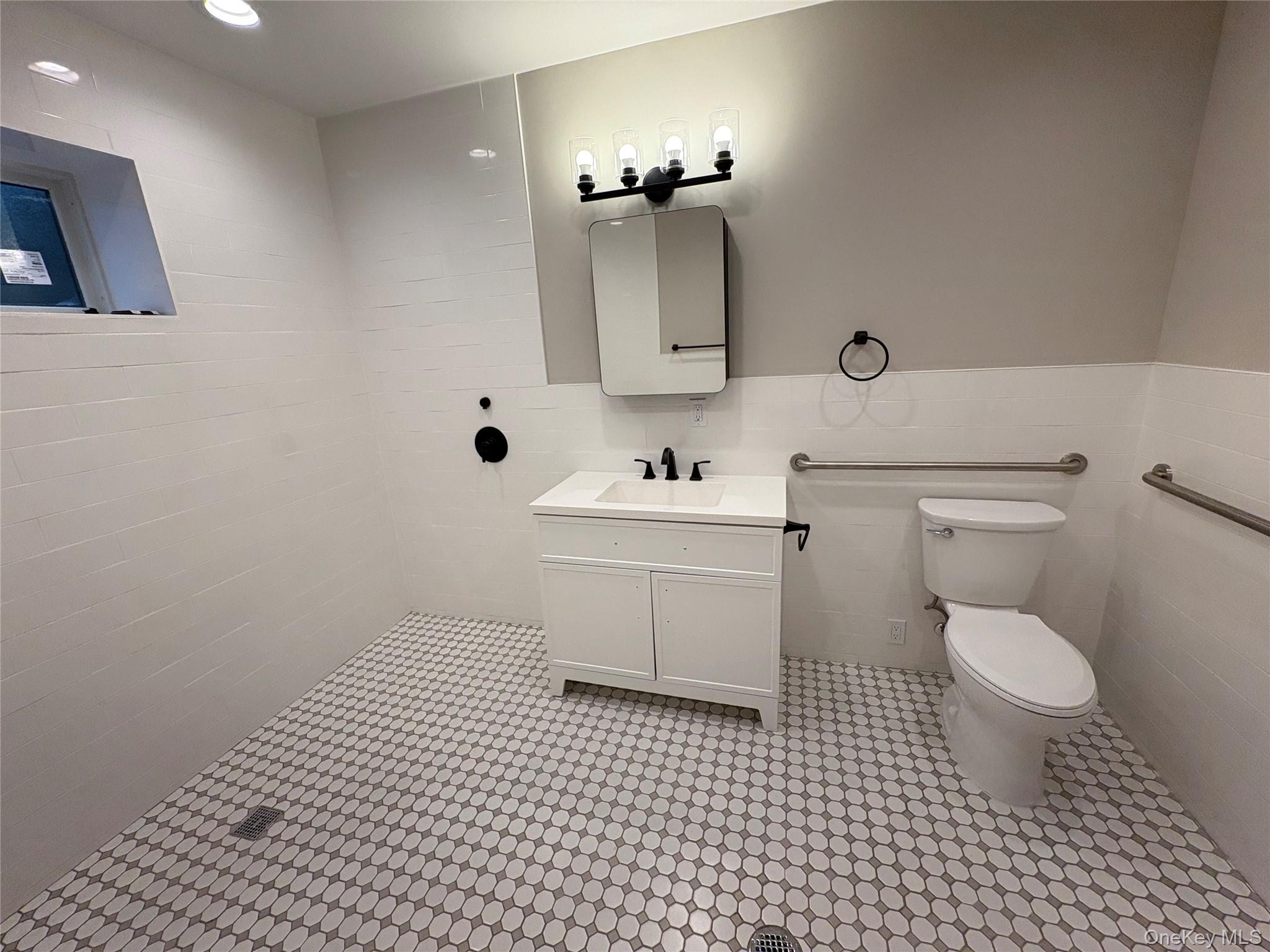 455 Sunrise Highway, Unit 1A West Babylon, NY 11704 - Photo 15 of 15 a bathroom with a sink toilet and mirror