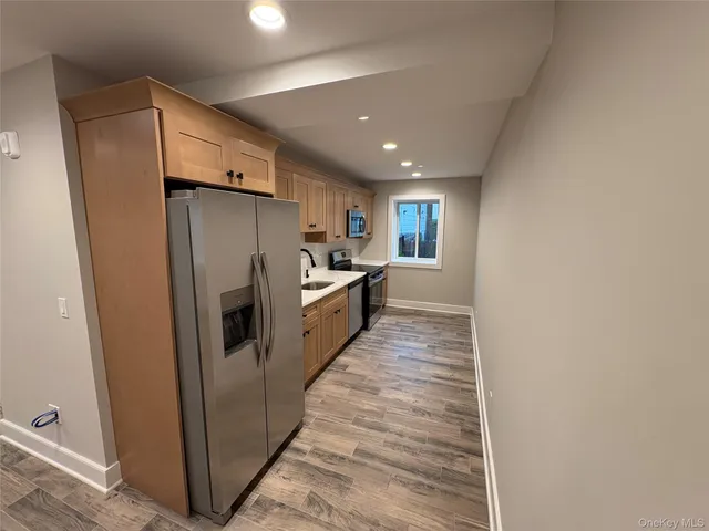 a kitchen with stainless steel appliances a refrigerator and a stove