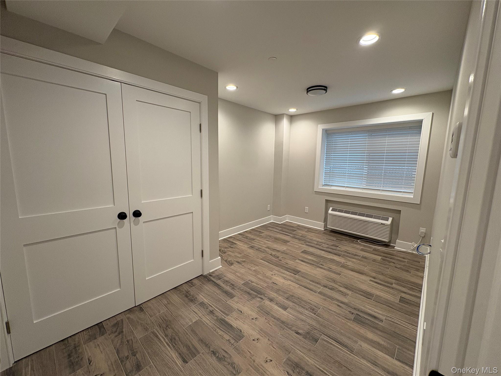 455 Sunrise Highway, Unit 1A West Babylon, NY 11704 - Photo 7 of 15 a view of a hallway with wooden floor