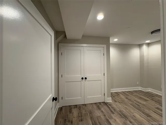 a view of room with wooden floor