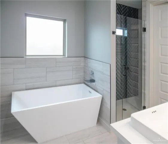a bathroom with a bathtub and shower