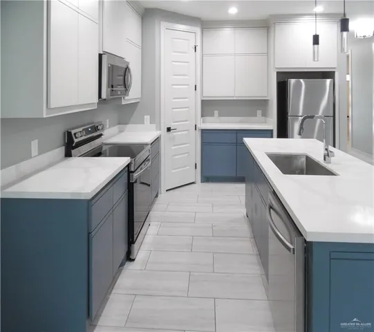 a kitchen with stainless steel appliances granite countertop a sink and dishwasher stove