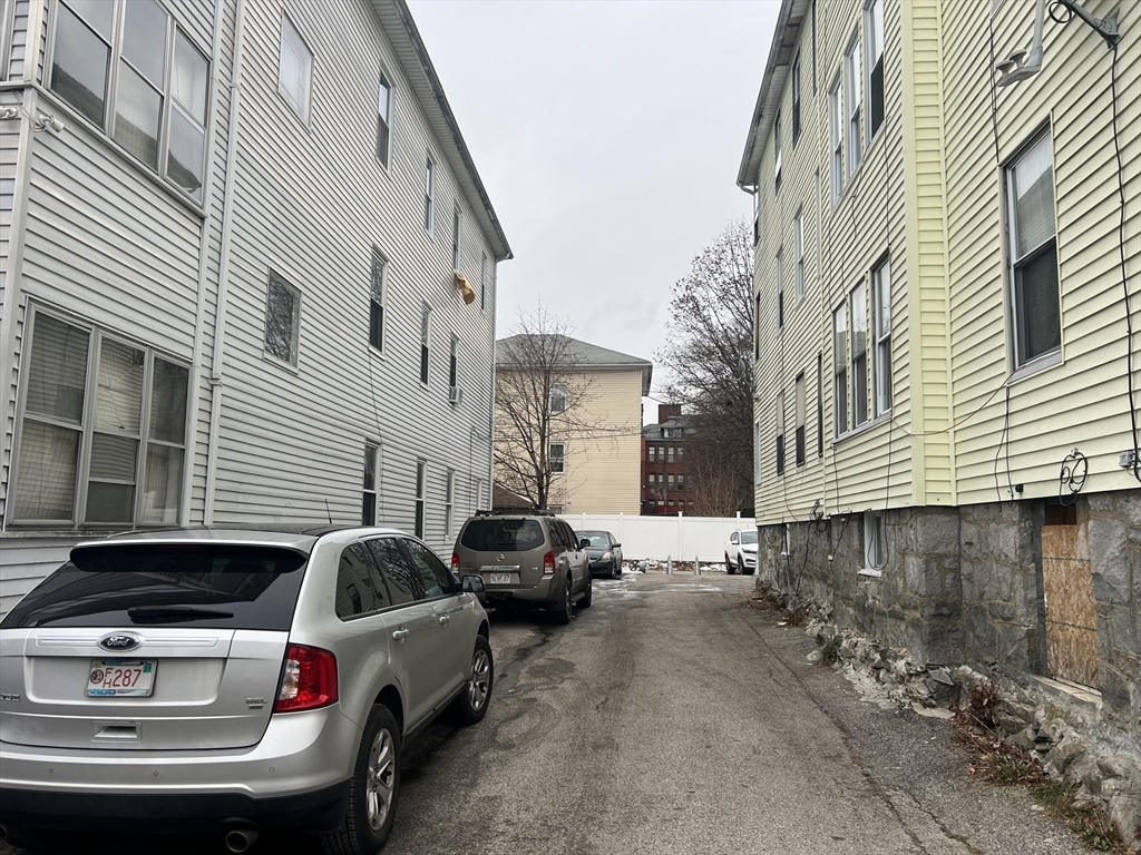 74 Esther Street Worcester, MA 01607 - Photo 4 of 5 a front view of a house with parking space