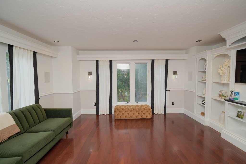 885 Randolph Street Canton, MA 02021 - Photo 14 of 40 a living room with furniture and a large mirror next to a window