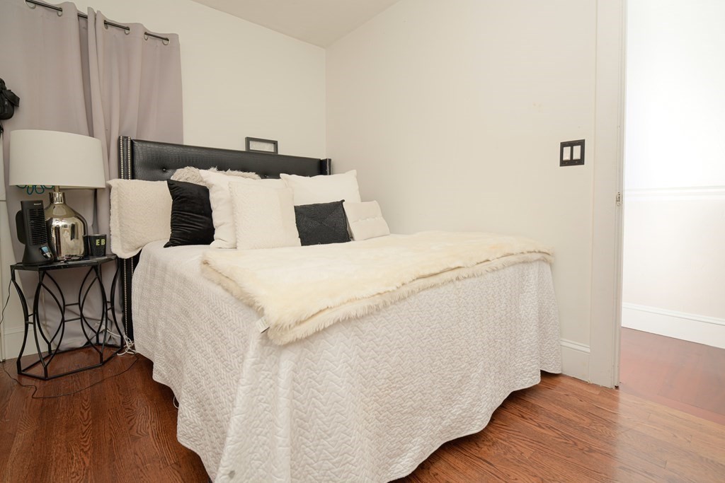 885 Randolph Street Canton, MA 02021 - Photo 18 of 40 a bed room with a bed and a night stand