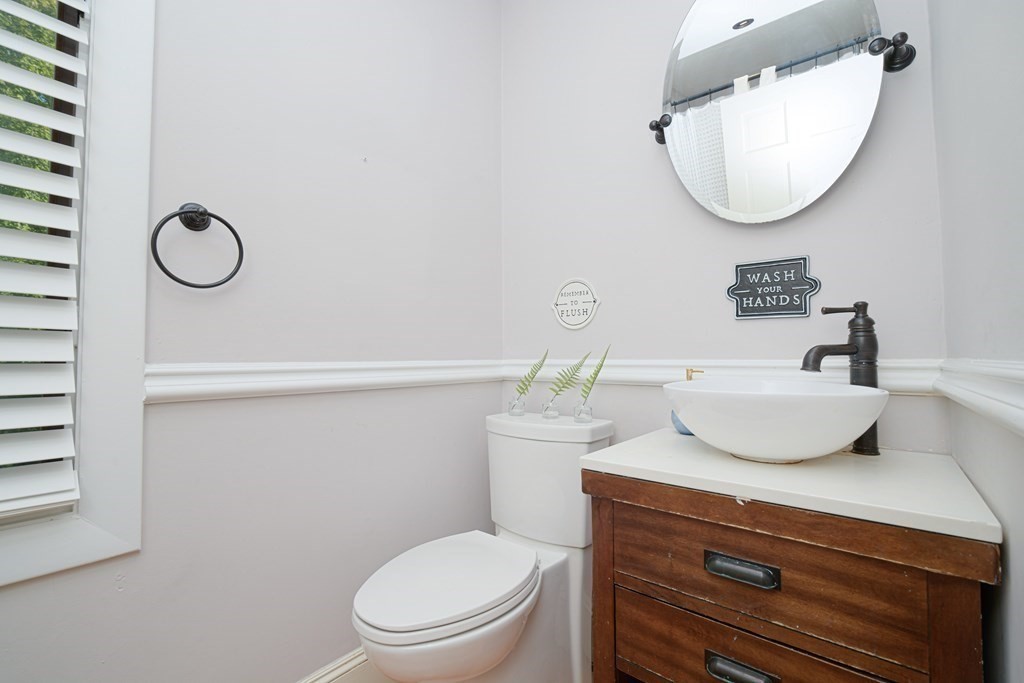 885 Randolph Street Canton, MA 02021 - Photo 19 of 40 a bathroom with a toilet a sink and mirror