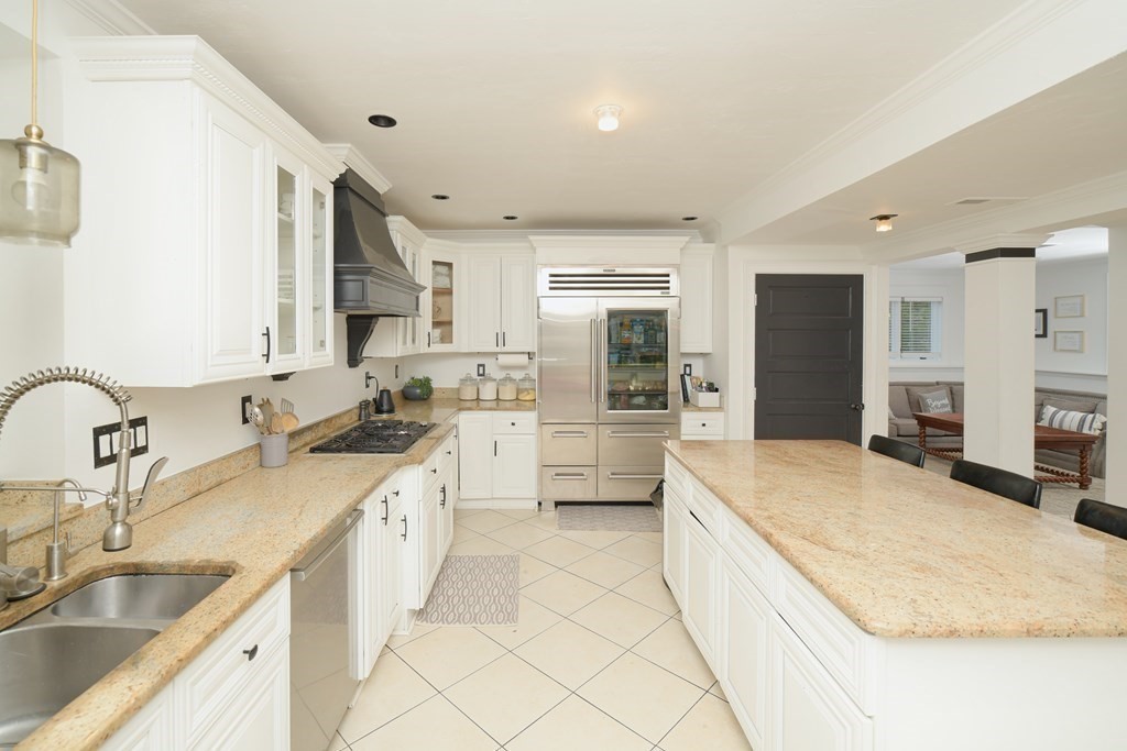 885 Randolph Street Canton, MA 02021 - Photo 2 of 40 a large white kitchen with kitchen island a sink stainless steel appliances and cabinets