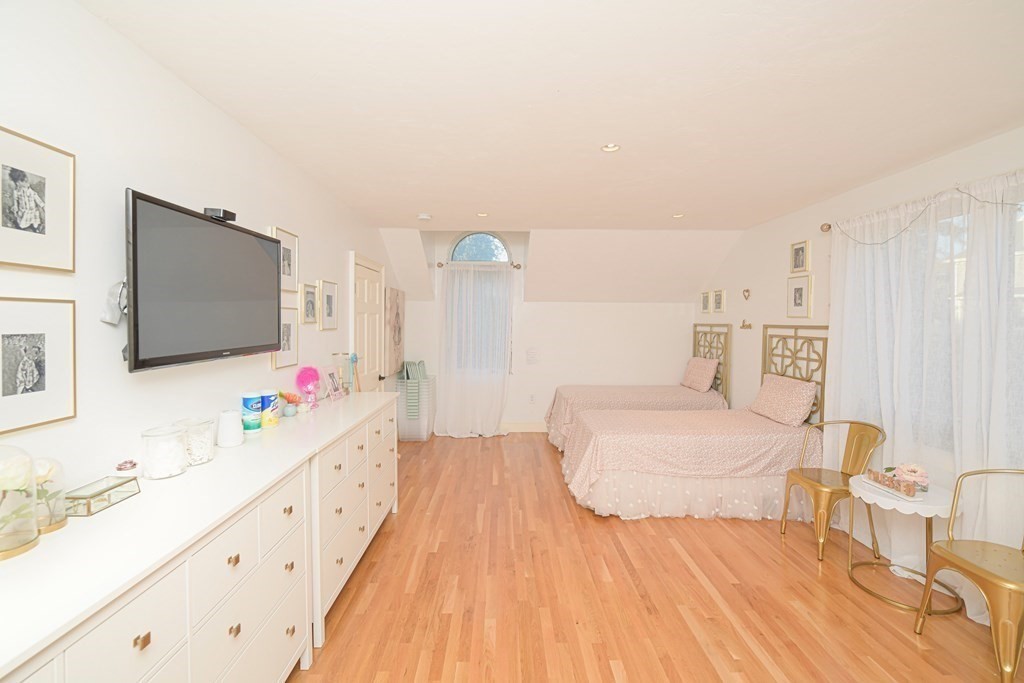 885 Randolph Street Canton, MA 02021 - Photo 26 of 40 a bedroom with a bed and a flat screen tv