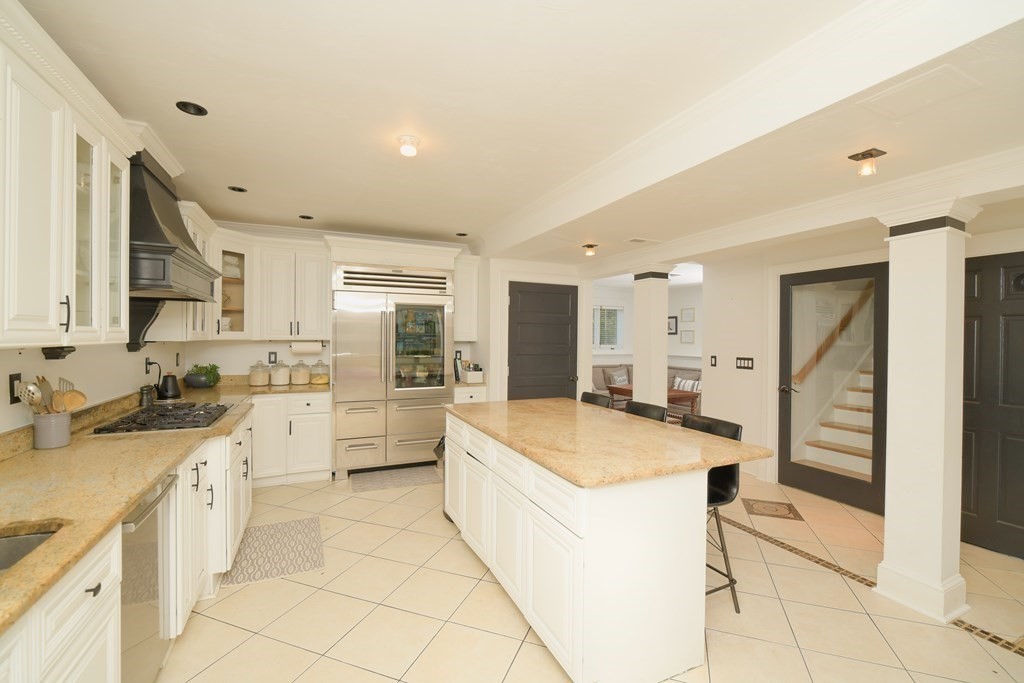 885 Randolph Street Canton, MA 02021 - Photo 3 of 40 a large kitchen with a stove a sink a washer dryer and a refrigerator