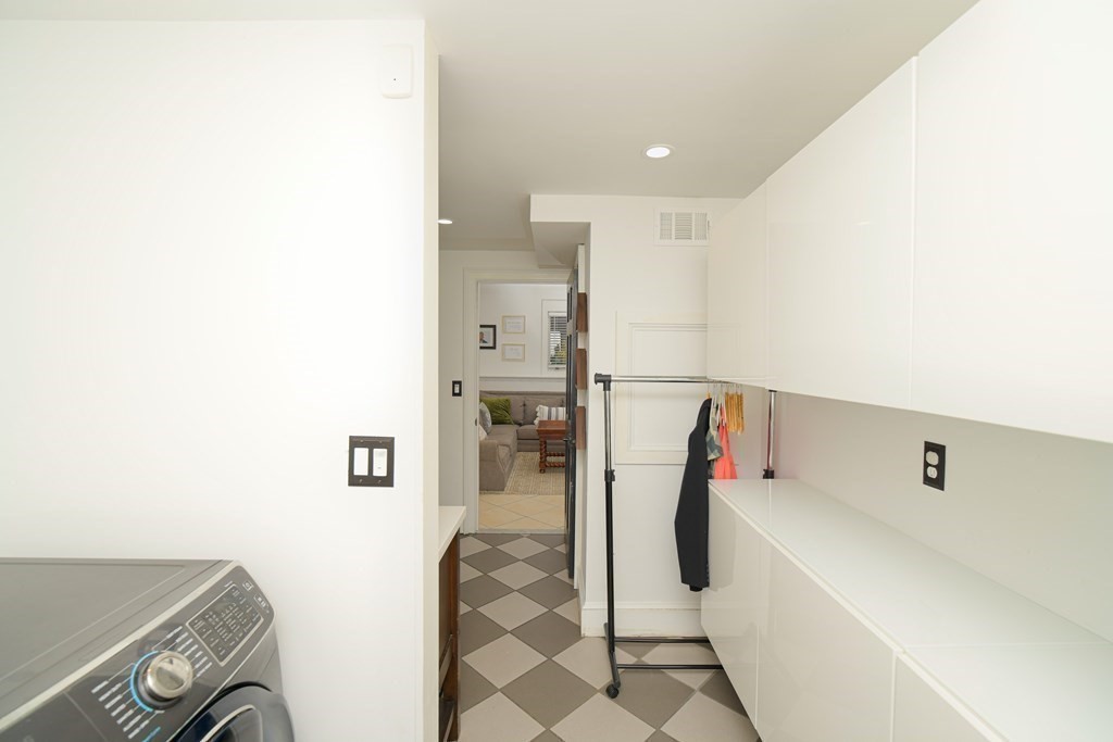 885 Randolph Street Canton, MA 02021 - Photo 32 of 40 a view of walk in closet with clothes and shoes