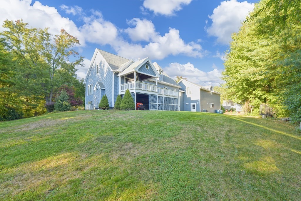 885 Randolph Street Canton, MA 02021 - Photo 36 of 40 a view of a white house next to a yard with big trees