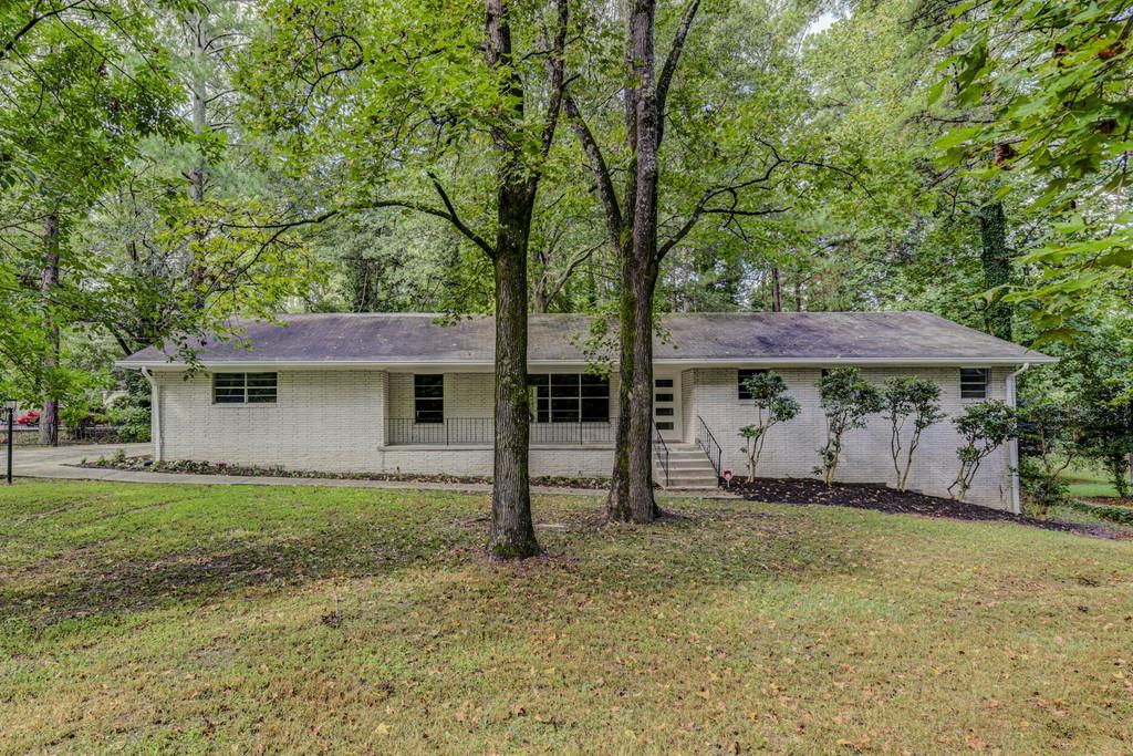 409 Harlan Road Southwest Atlanta, GA 30311 - Photo 1 of 1 a view of a house with a large tree and a yard