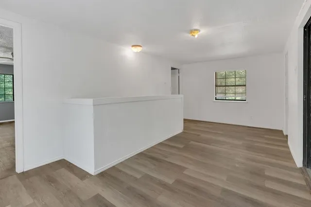 an empty room with windows and closet