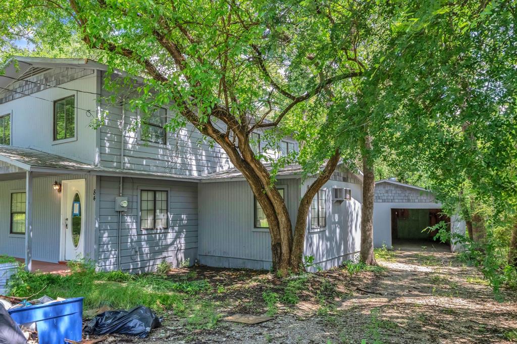 84 Natchez Road Pottsboro, TX 75076 - Photo 3 of 37 a front view of a house with garden