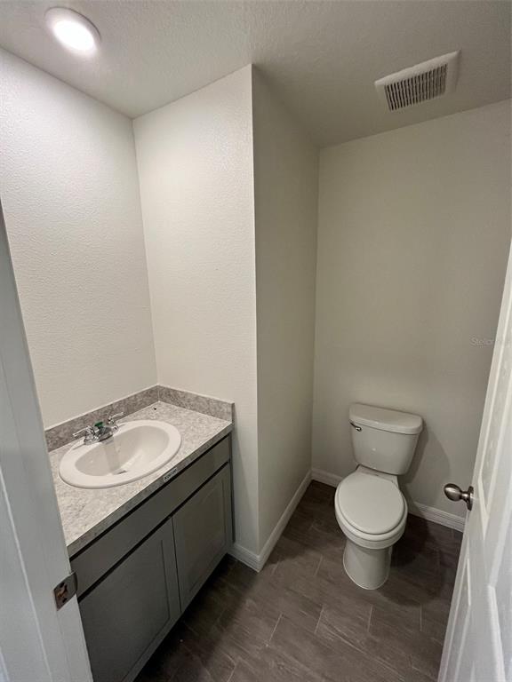 10300 Ruth Avenue Hastings, FL 32145 - Photo 7 of 9 a bathroom with a granite countertop toilet and sink