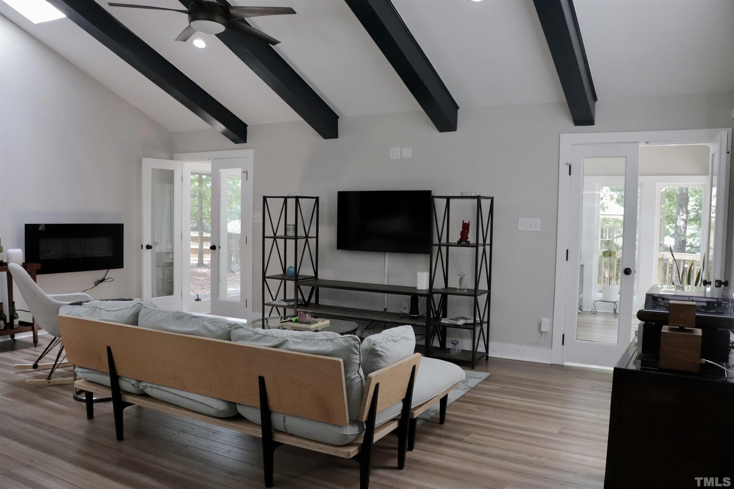 8001 Shellnut Road Raleigh, NC 27615 - Photo 3 of 22 a living room with furniture and a flat screen tv