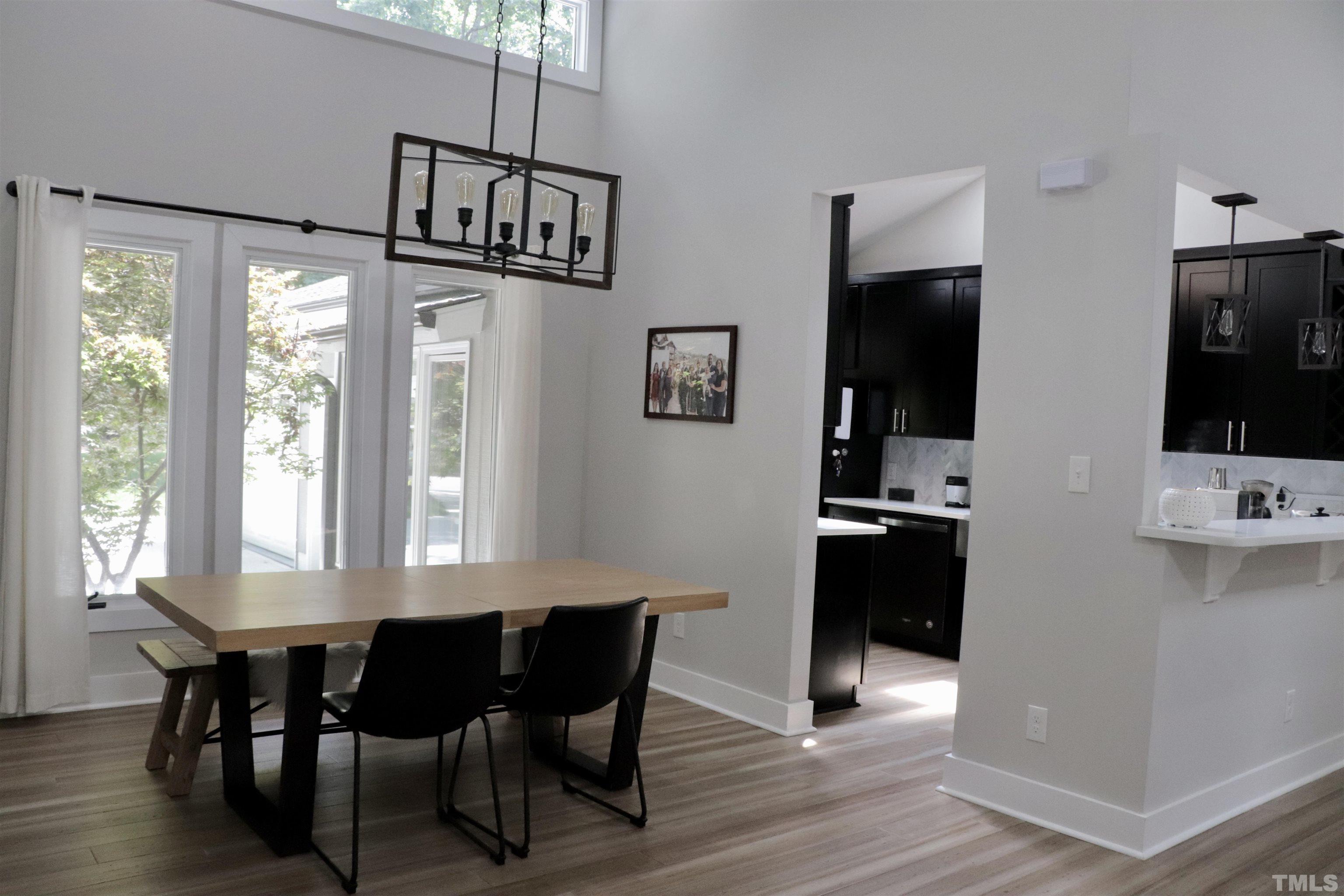 8001 Shellnut Road Raleigh, NC 27615 - Photo 6 of 22 a view of a dining room with furniture window and wooden floor