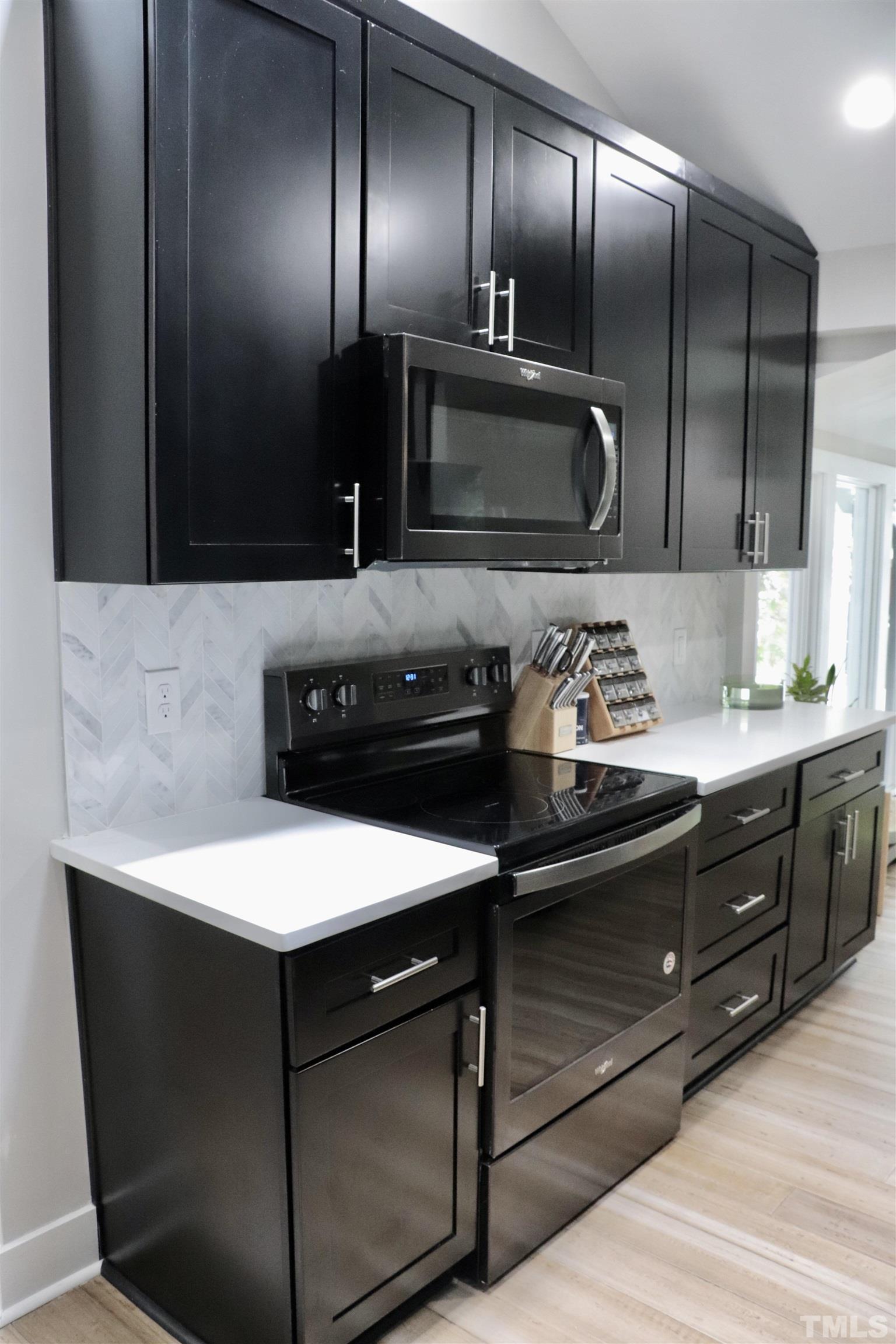 8001 Shellnut Road Raleigh, NC 27615 - Photo 8 of 22 a kitchen with a refrigerator and a sink