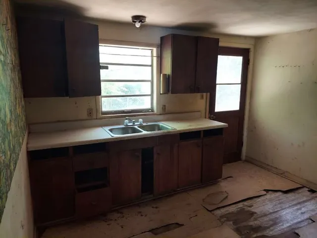 a kitchen with a sink and a window
