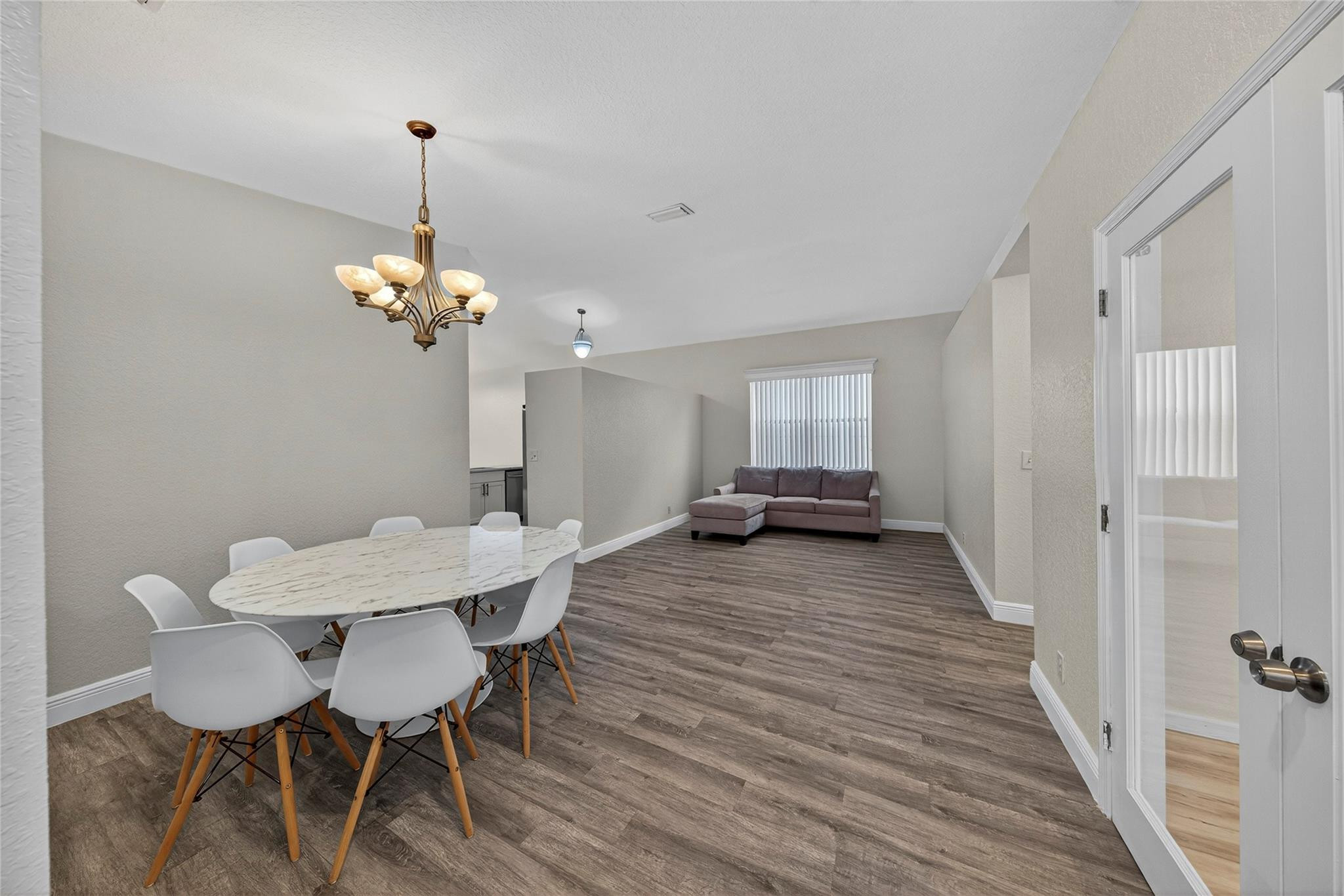 2424 Southwest 162nd Avenue Miramar, FL 33027 - Photo 11 of 44 a view of a dining room with furniture and wooden floor