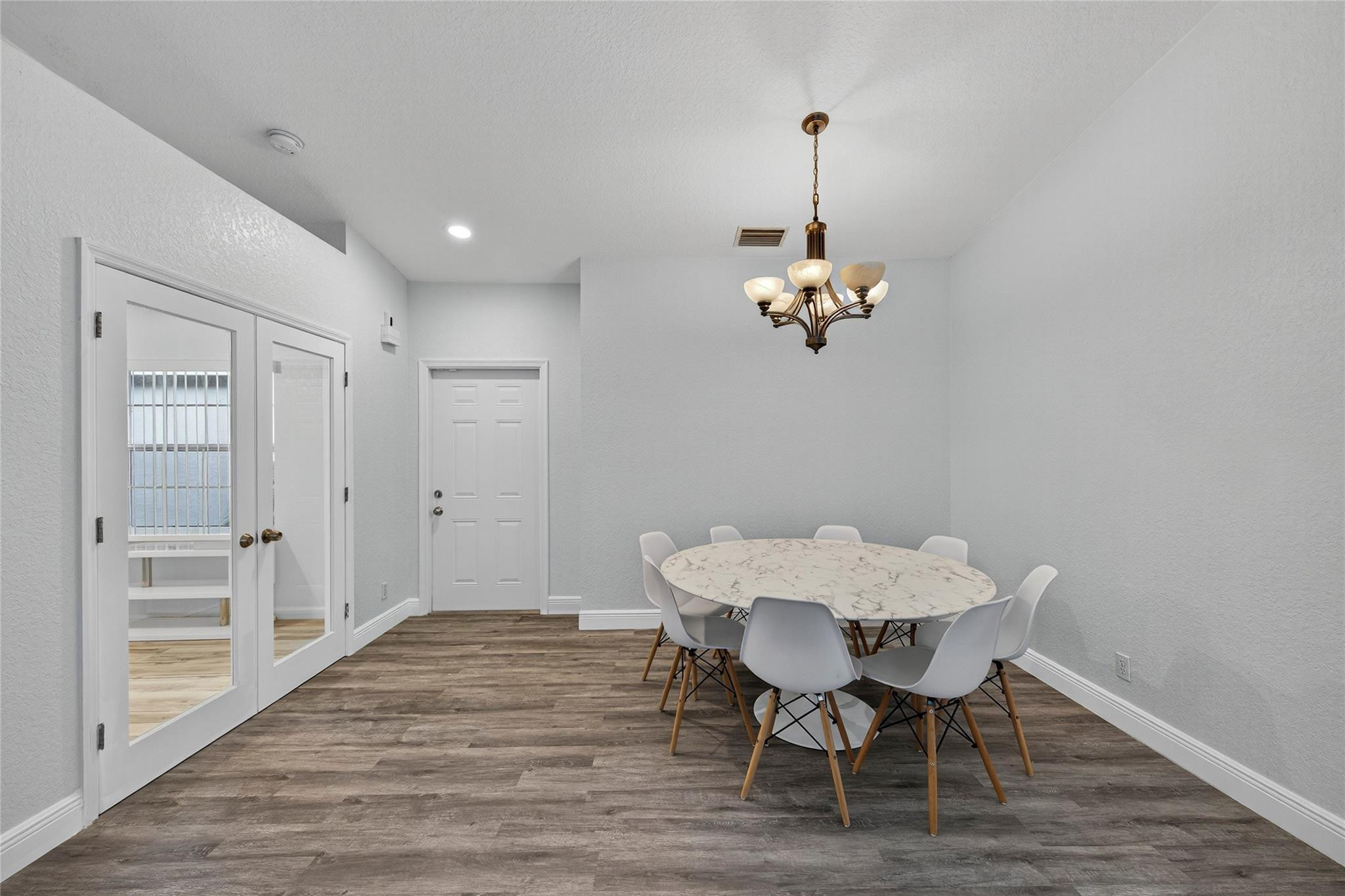 2424 Southwest 162nd Avenue Miramar, FL 33027 - Photo 12 of 44 a view of a dining room with furniture wooden floor and a chandelier
