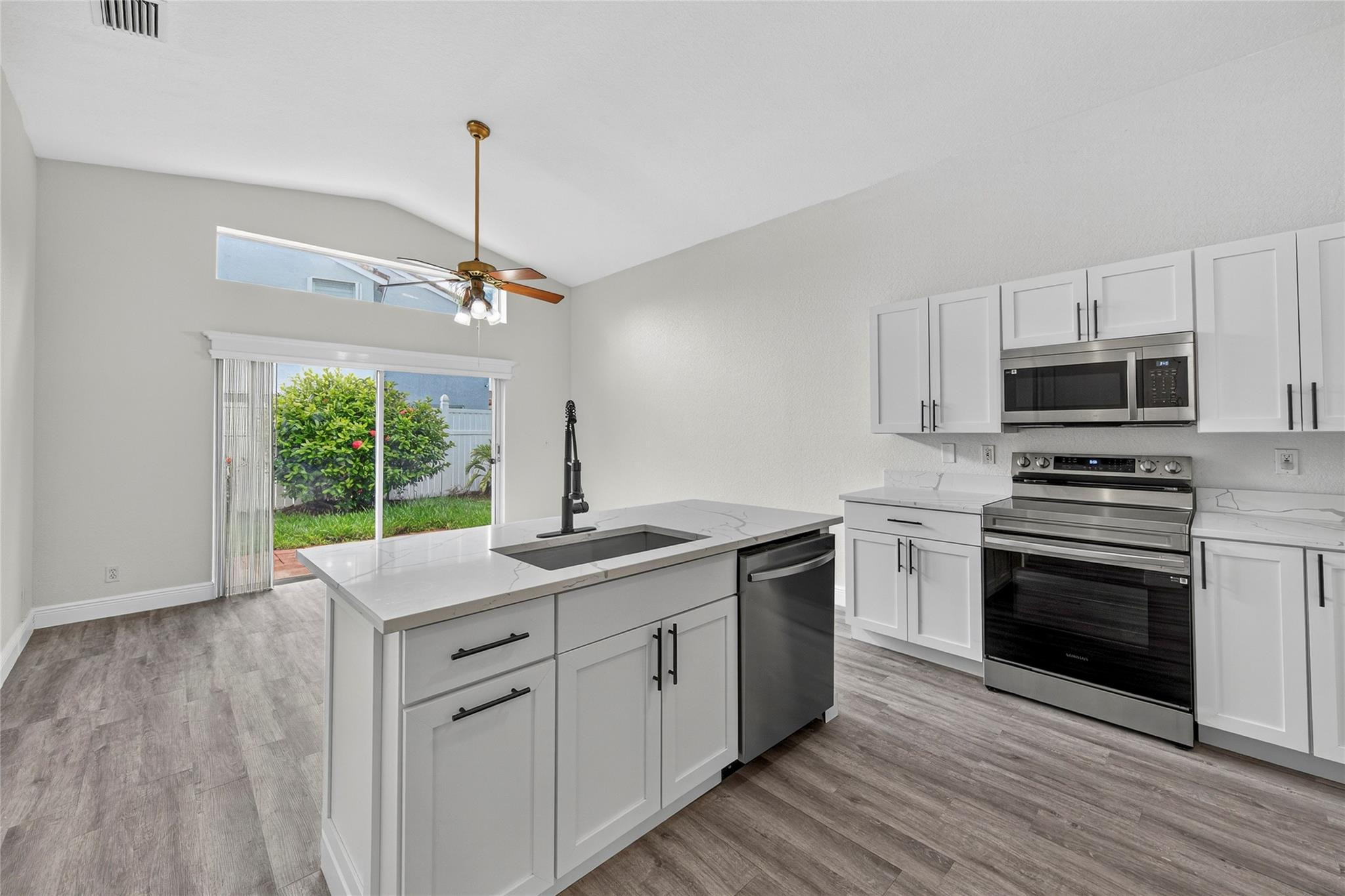 2424 Southwest 162nd Avenue Miramar, FL 33027 - Photo 15 of 44 a kitchen with a sink stove and microwave