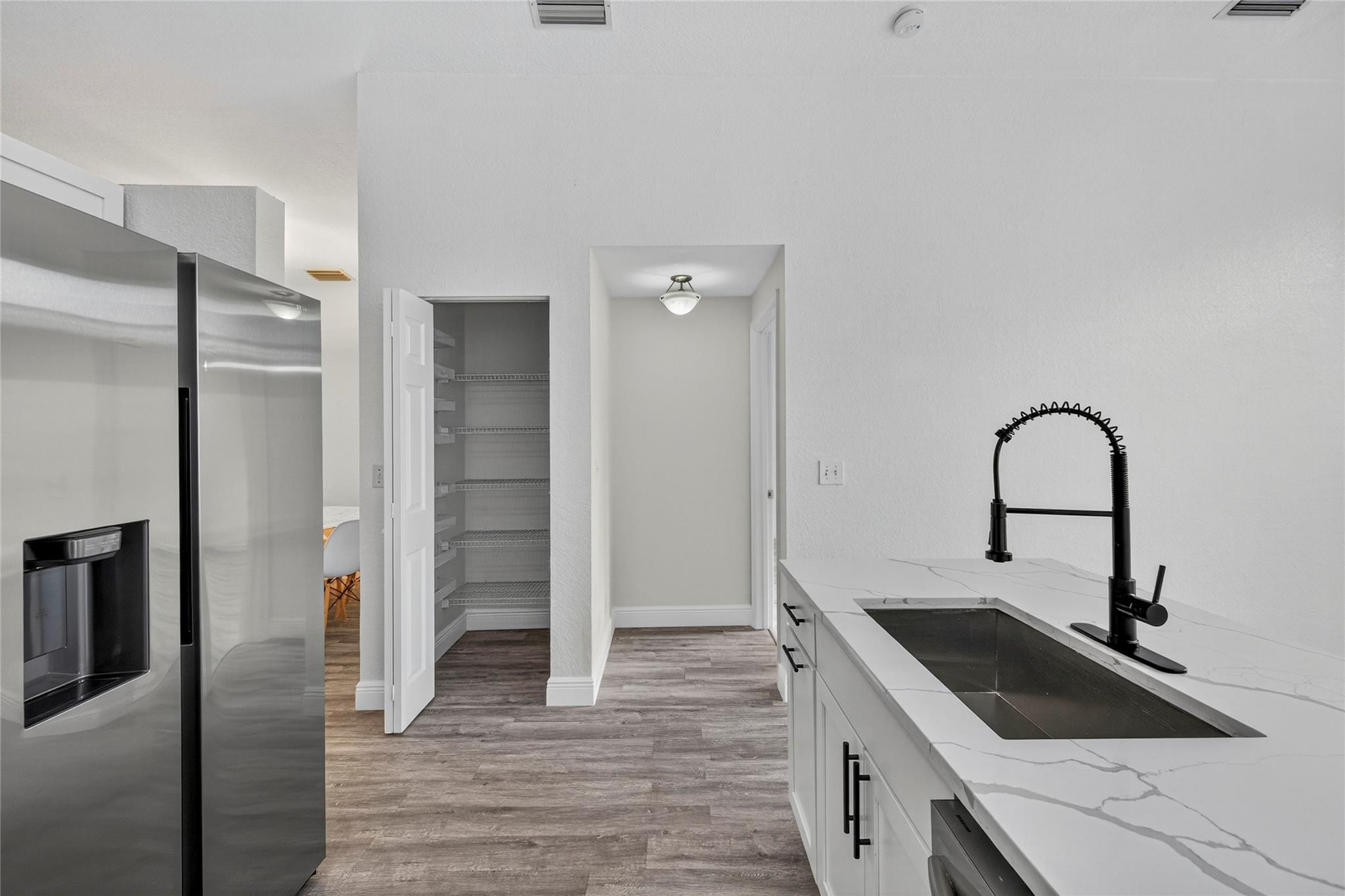2424 Southwest 162nd Avenue Miramar, FL 33027 - Photo 16 of 44 a kitchen with a sink and a refrigerator