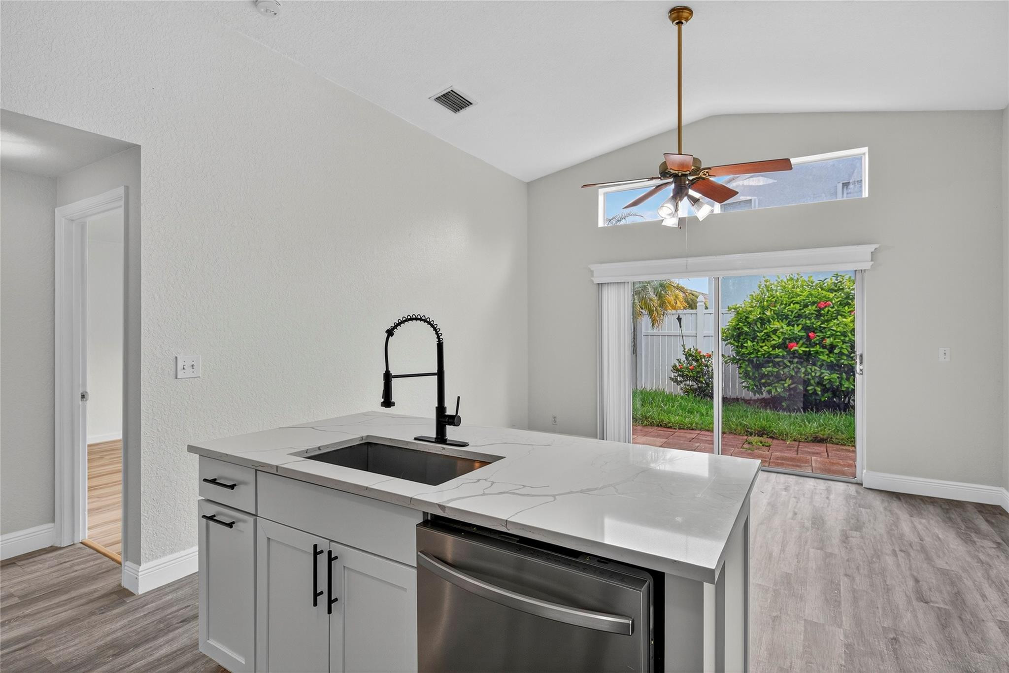 2424 Southwest 162nd Avenue Miramar, FL 33027 - Photo 20 of 44 a kitchen with a sink a counter and a wooden floor