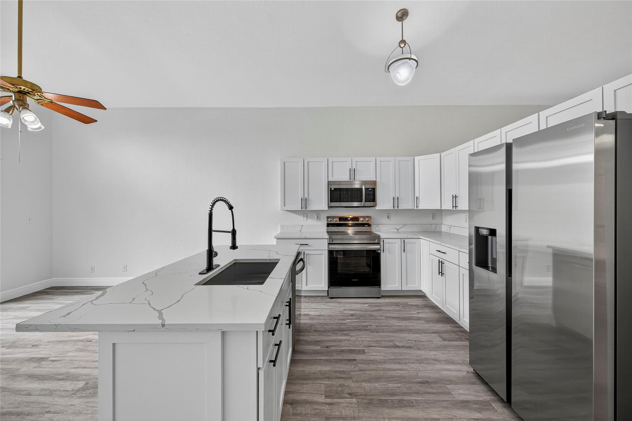 2424 Southwest 162nd Avenue Miramar, FL 33027 - Photo 2 of 44 a kitchen with refrigerator cabinets and a sink