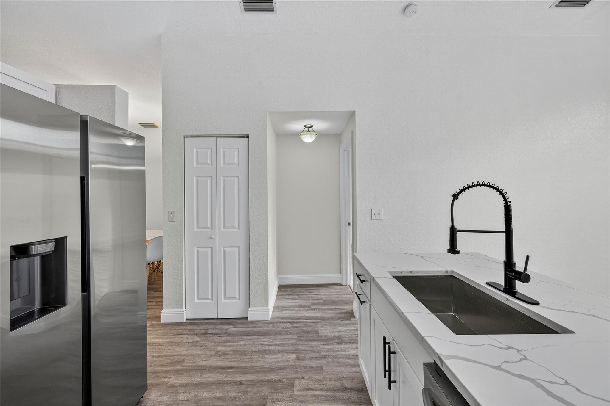 2424 Southwest 162nd Avenue Miramar, FL 33027 - Photo 21 of 44 a kitchen with a sink and a refrigerator