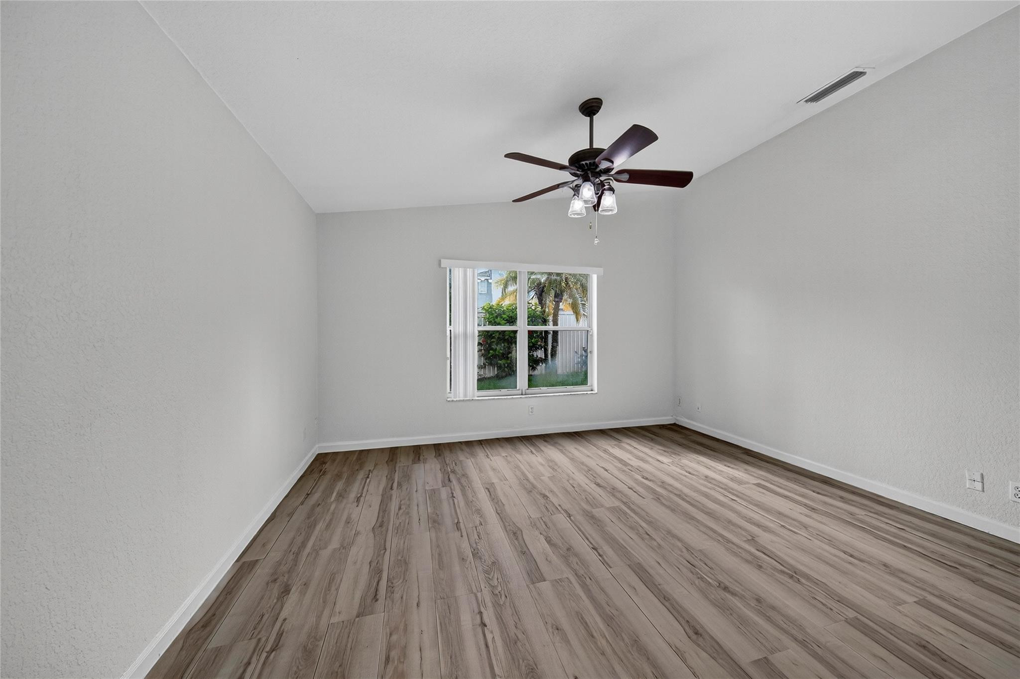 2424 Southwest 162nd Avenue Miramar, FL 33027 - Photo 23 of 44 a view of room with hardwood floor ceiling fan and window