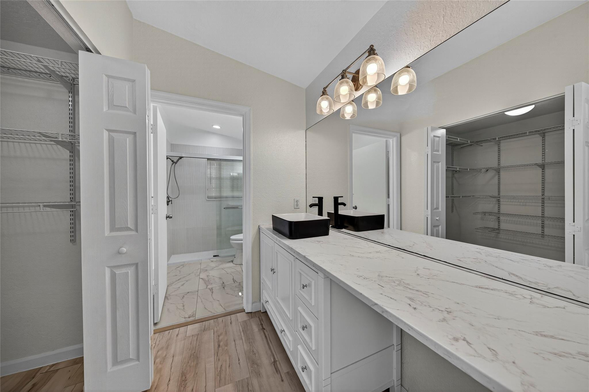 2424 Southwest 162nd Avenue Miramar, FL 33027 - Photo 24 of 44 a bathroom with a granite countertop sink a large mirror a shower and a bathtub