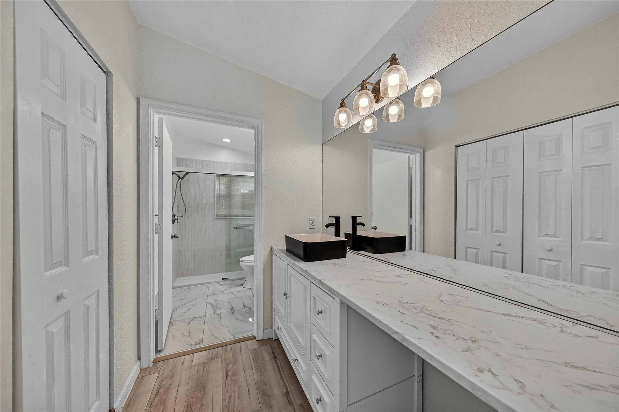 2424 Southwest 162nd Avenue Miramar, FL 33027 - Photo 30 of 44 a bathroom with a granite countertop double vanity sink a mirror and shower