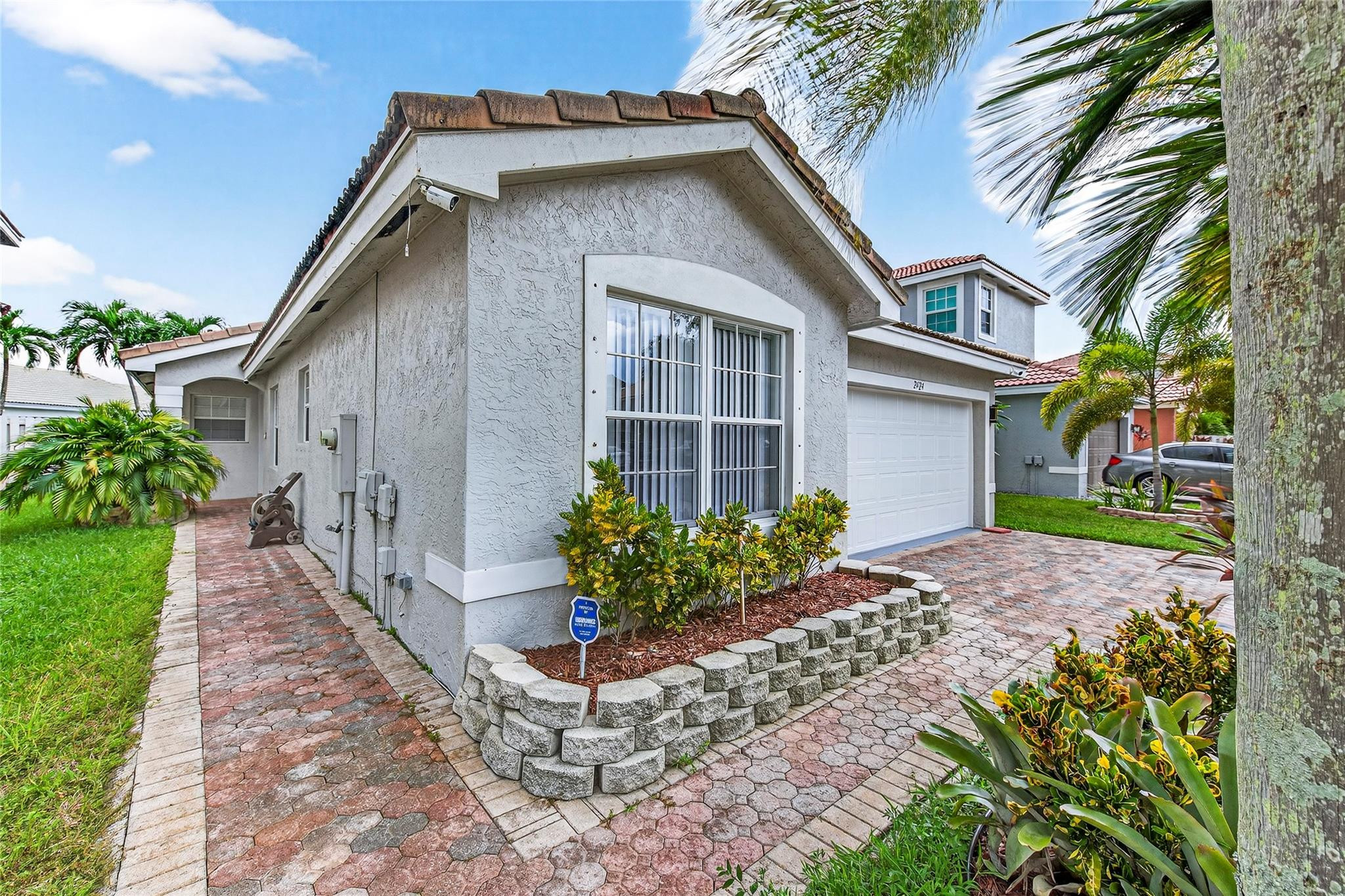 2424 Southwest 162nd Avenue Miramar, FL 33027 - Photo 4 of 44 a front view of a house with garden
