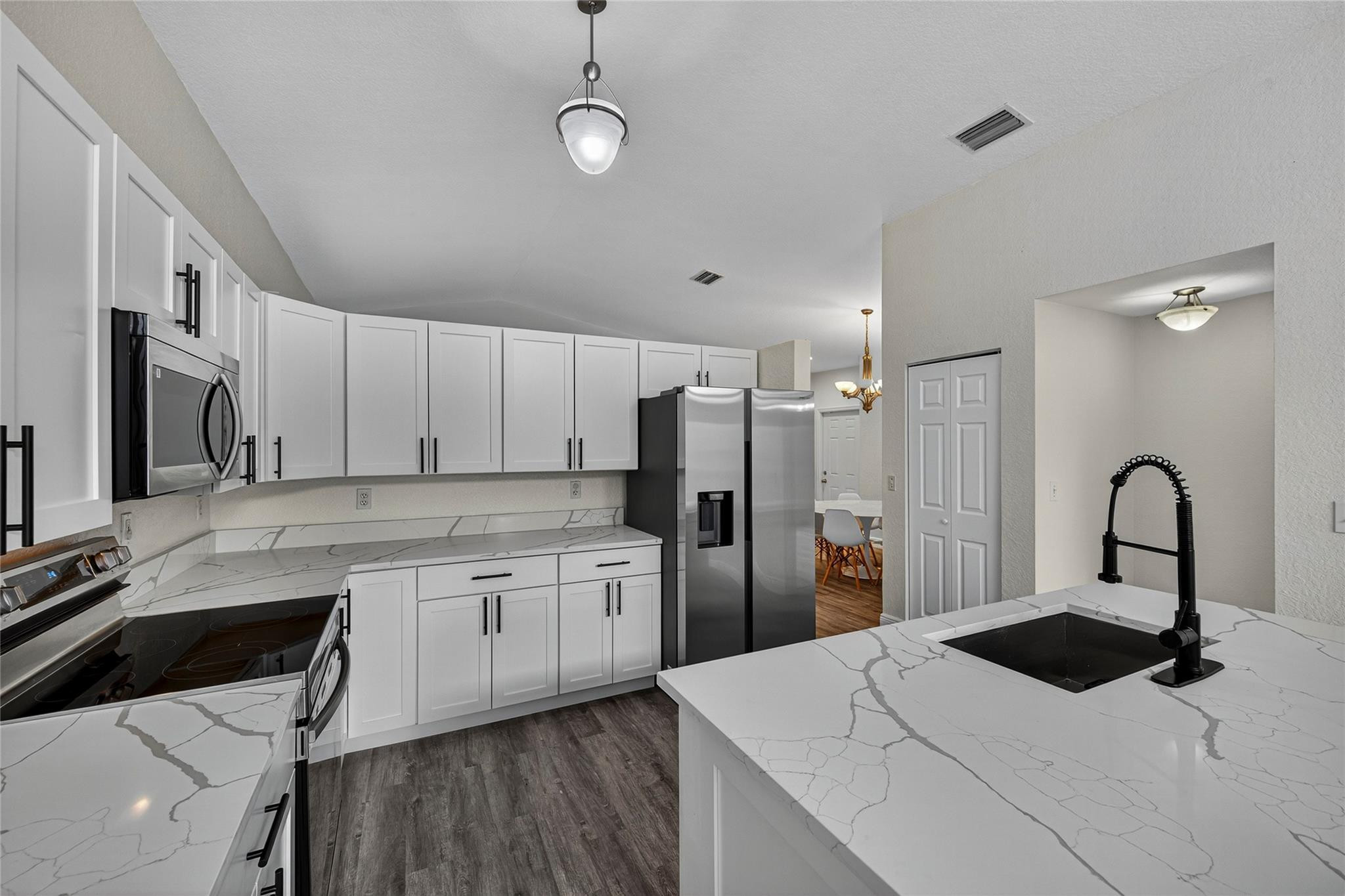 2424 Southwest 162nd Avenue Miramar, FL 33027 - Photo 10 of 44 a kitchen with stainless steel appliances kitchen island a sink a refrigerator and cabinets