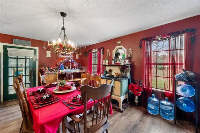 a view of a dining room with furniture and chandelier