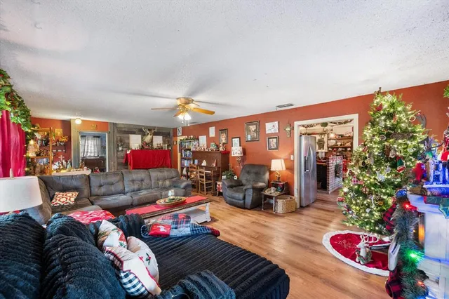 a living room with furniture and a floor to ceiling window