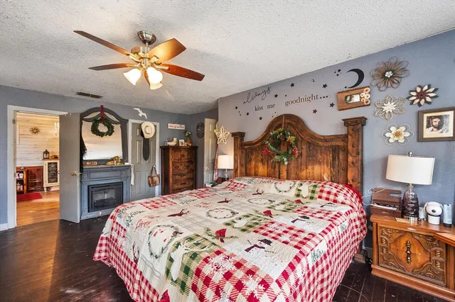 a bedroom with a bed a large window with table and chairs