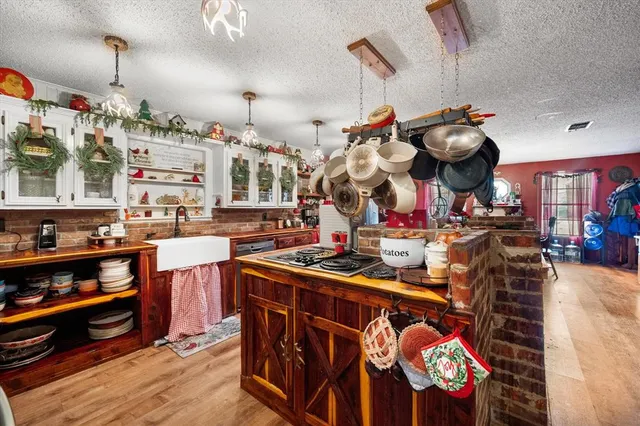 a kitchen with stainless steel appliances granite countertop a stove and cabinets