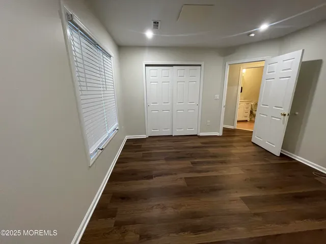 a view of an entryway with wooden floor