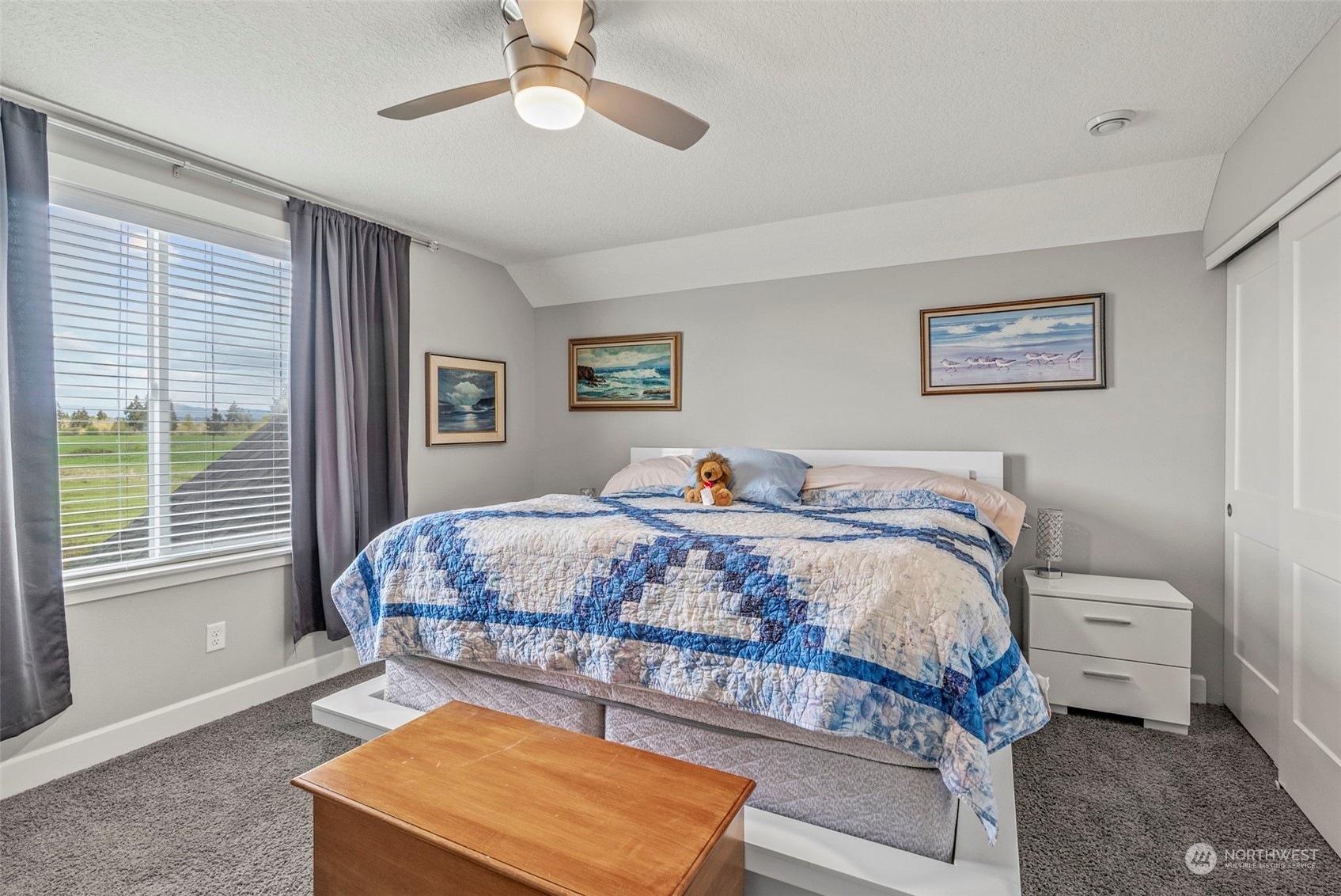 4578 North Noble Loop Ridgefield, WA 98642 - Photo 26 of 40 a bedroom with a bed a window and a chandelier