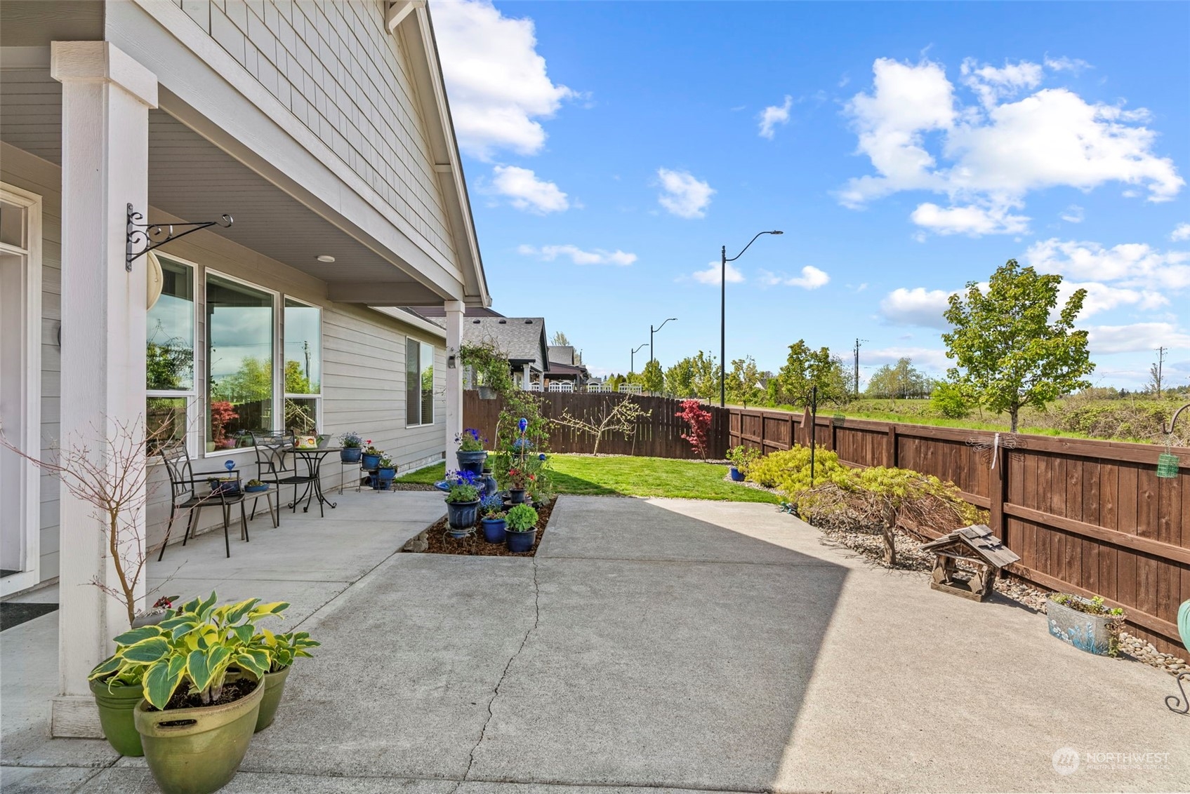4578 North Noble Loop Ridgefield, WA 98642 - Photo 31 of 40 a view of a patio with a table and chairs and potted plants
