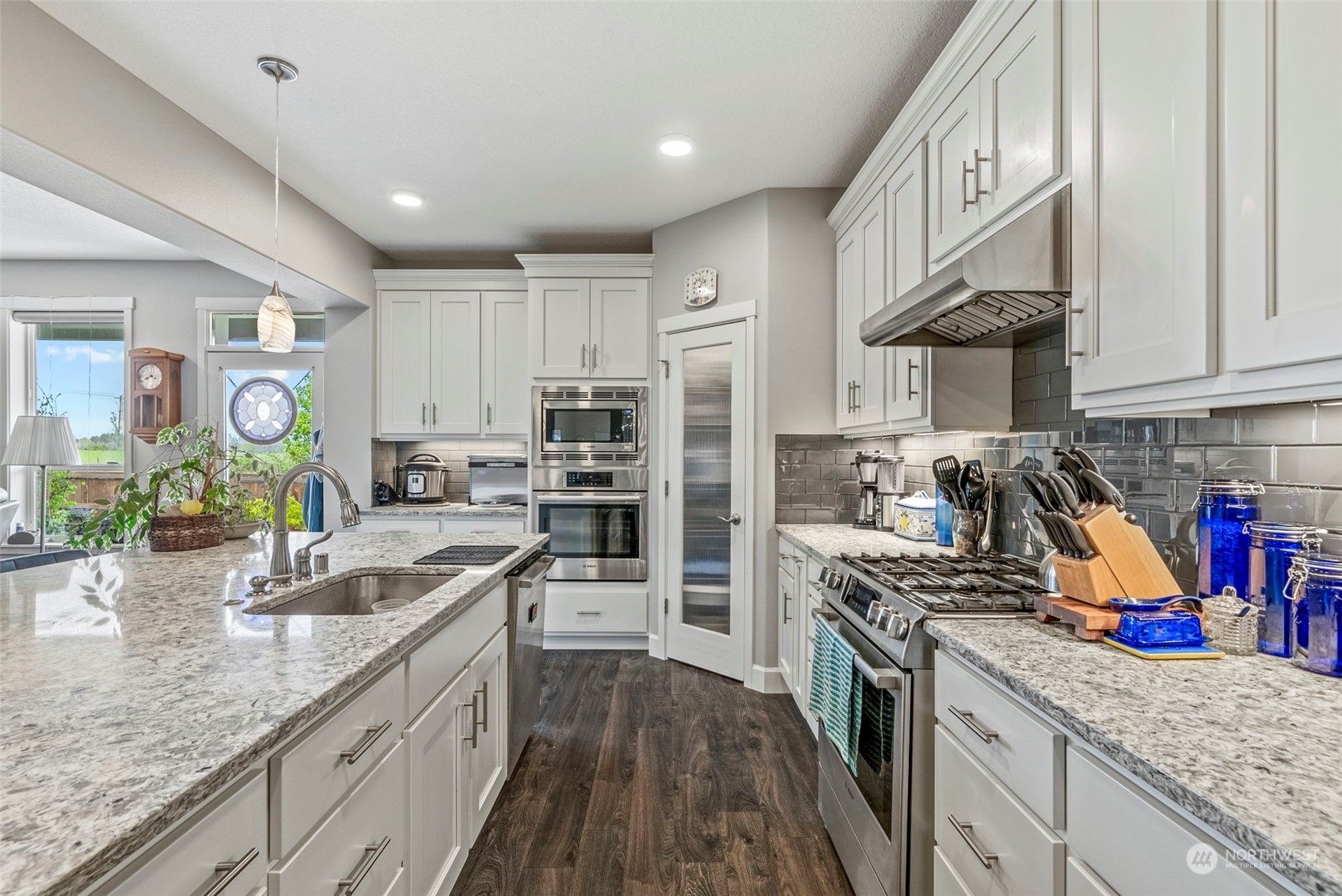 4578 North Noble Loop Ridgefield, WA 98642 - Photo 10 of 40 a kitchen with stainless steel appliances granite countertop a sink stove and refrigerator