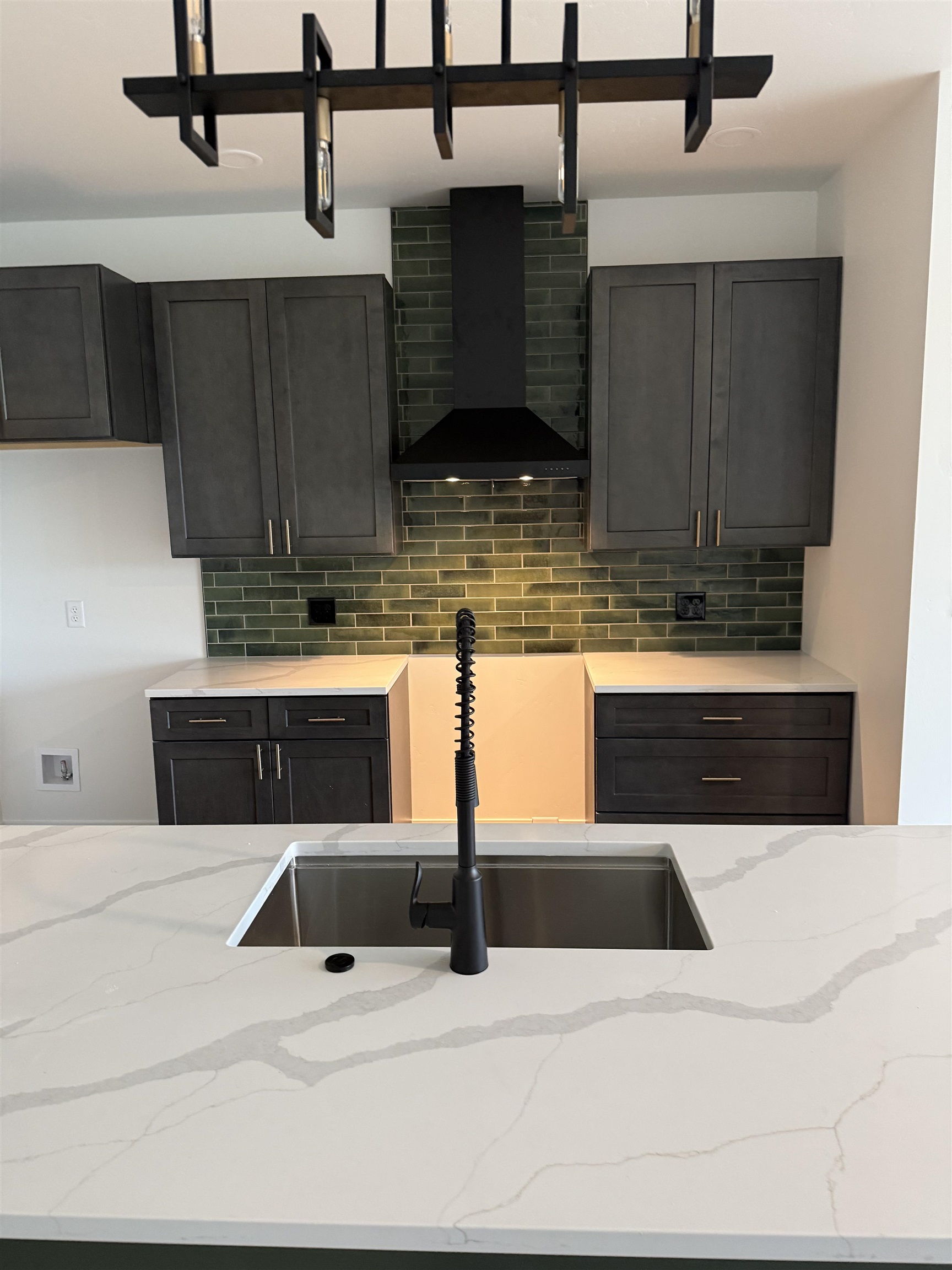214 Limberpine Circle Parachute, CO 81635 - Photo 4 of 24 a kitchen with stainless steel appliances kitchen island granite countertop a sink a stove and cabinets