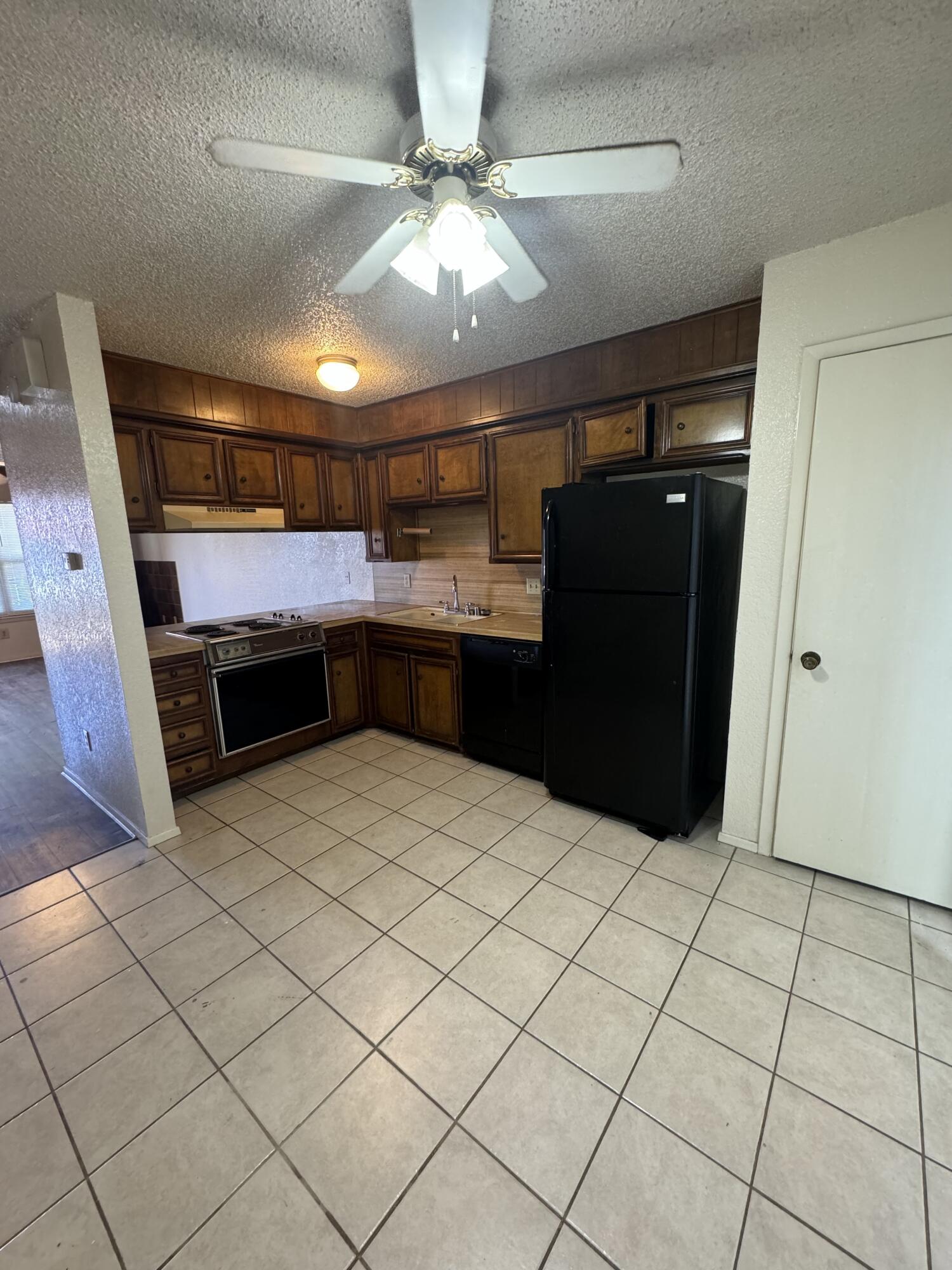 6111 36th Street, Unit C Lubbock, TX 79407 - Photo 2 of 6 a kitchen with stainless steel appliances a refrigerator and a cabinets