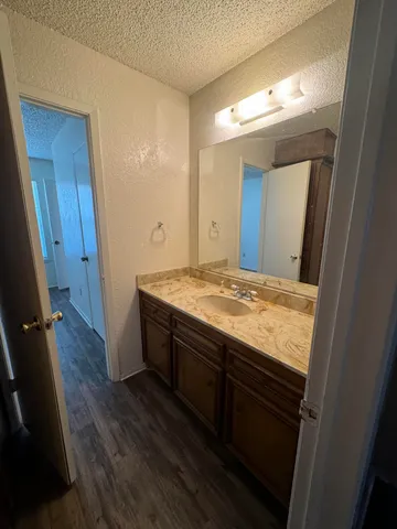 a view of bathroom with a sink and mirror